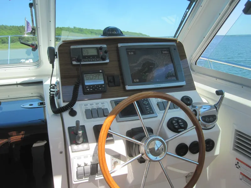 Slide: The Image of 2014 Back Cove 34 Hard Top helm with steering wheel and navigation equipment. - 31