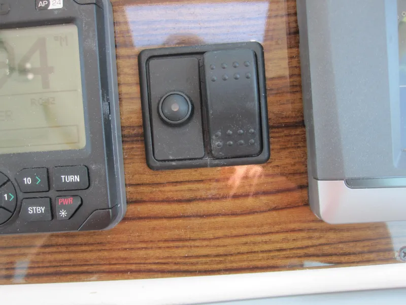 Slide: The Image of Control panel of 2014 Back Cove 34 Hard Top boat with wood finish. - 32