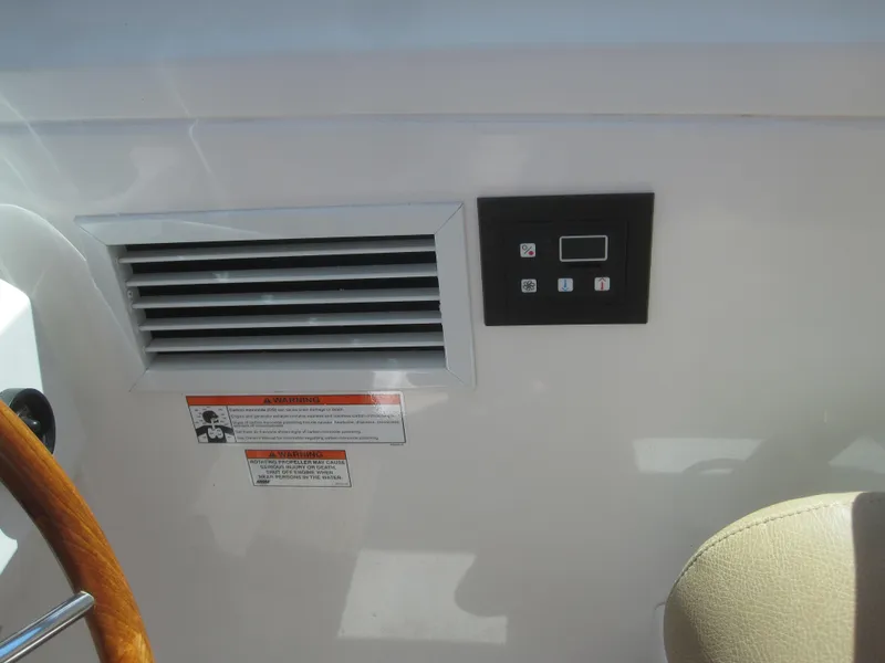 Slide: The Image of 2014 Back Cove 34 Hard Top control panel and vent detail. - 36