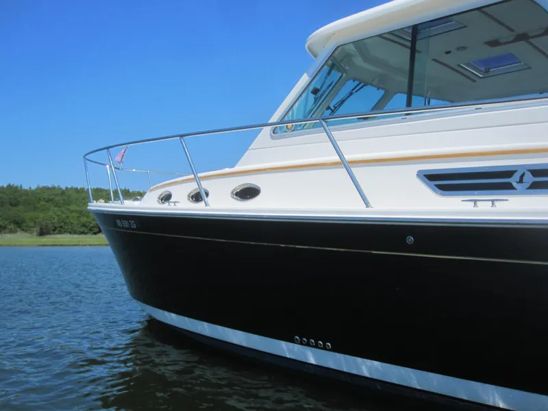 Slide: The Image of 2014 Back Cove 34 Hard Top boat on water, side view. - 4