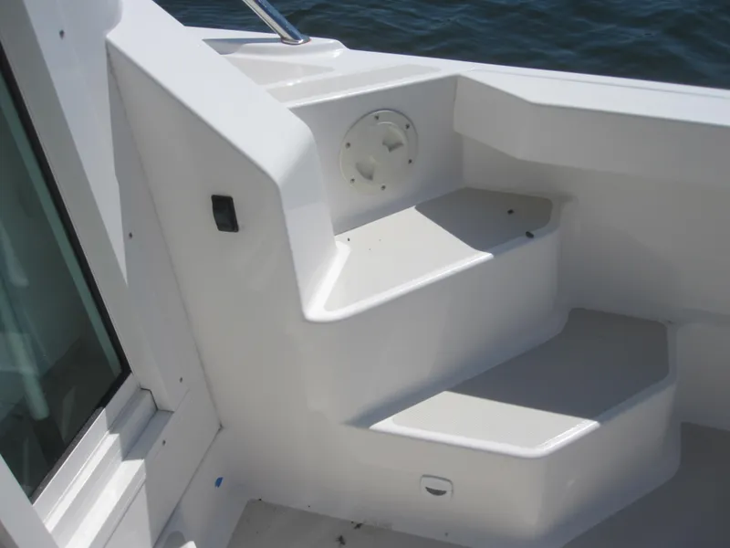 Slide: The Image of 2014 Back Cove 34 Hard Top boat interior steps, white finish, near water. - 47