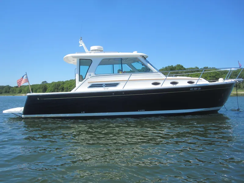Slide: The Image of 2014 Back Cove 34 Hard Top boat on calm water, side view. - 6