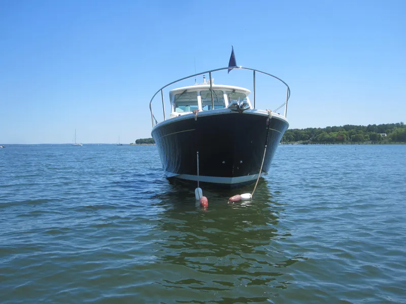 Slide: The Image of 2014 Back Cove 34 Hard Top boat on calm water, front view. - 8