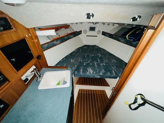 Slide: The Image of 2006 Carolina Classic 28 boat interior with cozy cabin and kitchenette. - 14