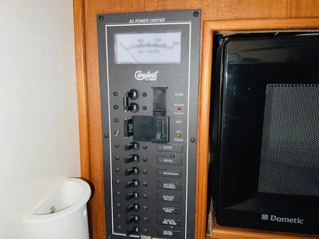 Slide: The Image of AC power center panel in a 2006 Carolina Classic 28 boat. - 17