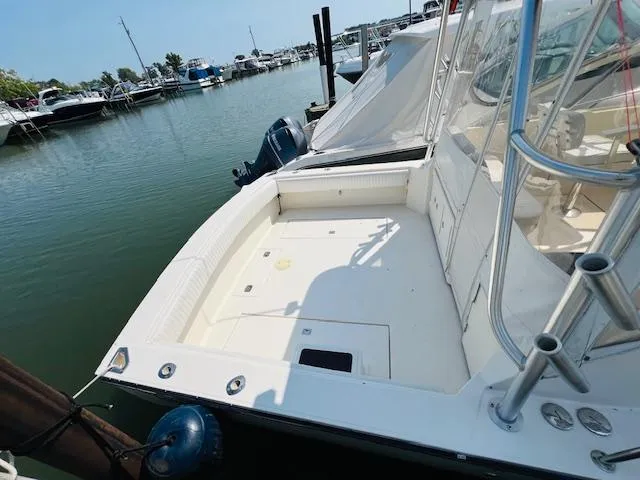 Slide: The Image of 2006 Carolina Classic 28 boat docked at marina, spacious deck area. - 4