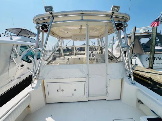 Slide: The Image of 2006 Carolina Classic 28 boat docked, featuring a spacious cockpit and sturdy frame. - 5