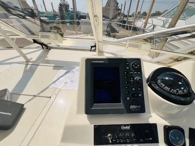 Slide: The Image of 2006 Carolina Classic 28 boat dashboard with navigation equipment and compass. - 8