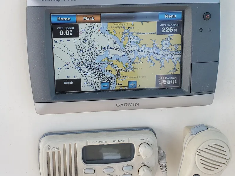 Slide: The Image of Garmin GPS and Icom radio on 1999 Pursuit 2470 Walkaround boat dashboard. - 10