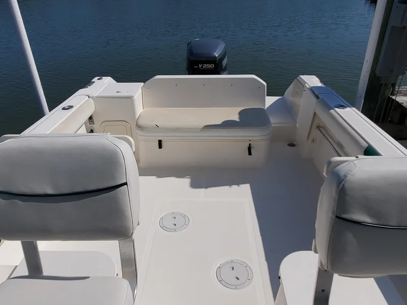 Slide: The Image of 1999 Pursuit 2470 Walkaround boat interior with seating and Yamaha V250 outboard motor. - 17
