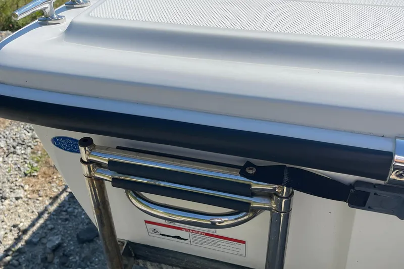 Slide: The Image of 2022 Edgewater 158CS boat ladder and handle detail, showcasing stainless steel construction. - 11