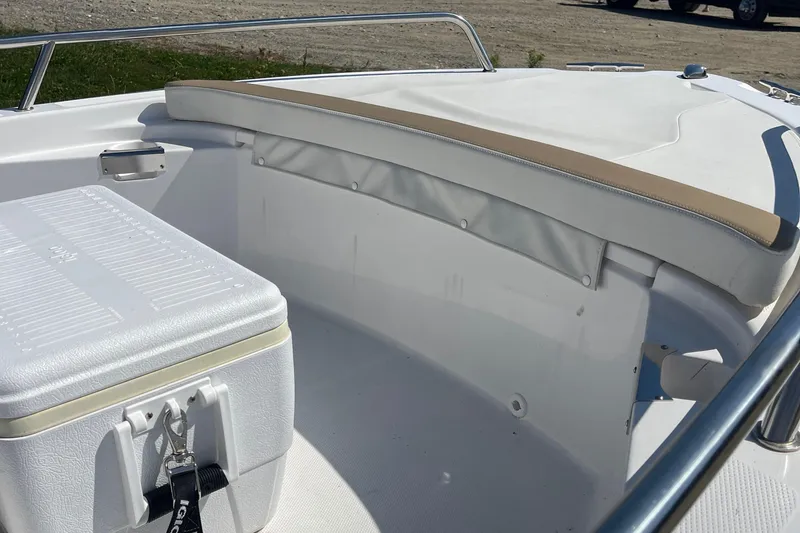 Slide: The Image of 2022 Edgewater 158CS boat interior with seating and cooler on deck. - 16