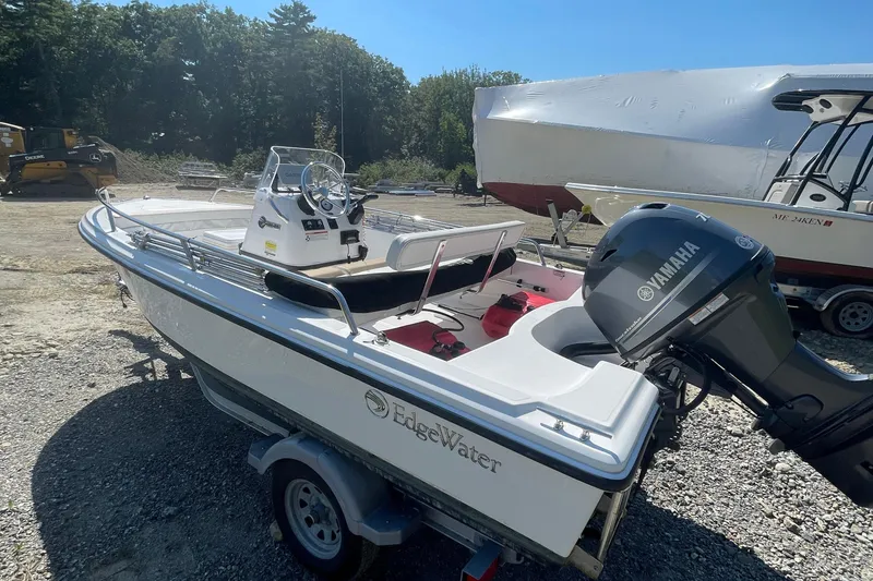 Slide: The Image of 2022 Edgewater 158CS boat with Yamaha outboard motor on a trailer, parked outdoors. - 5
