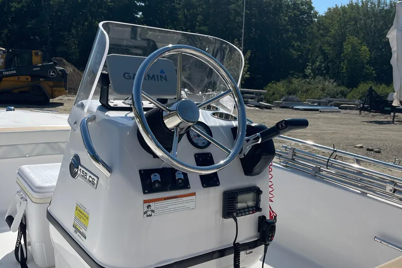 Slide: The Image of 2022 Edgewater 158CS boat console with steering wheel and Garmin navigation system. - 8
