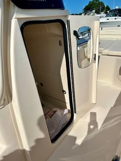 Slide: The Image of 2024 Grady-White Fisherman 216 boat interior with open storage compartment. - 10