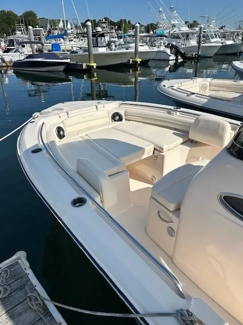 Slide: The Image of 2024 Grady-White Fisherman 216 boat docked in marina, showcasing spacious seating area. - 13