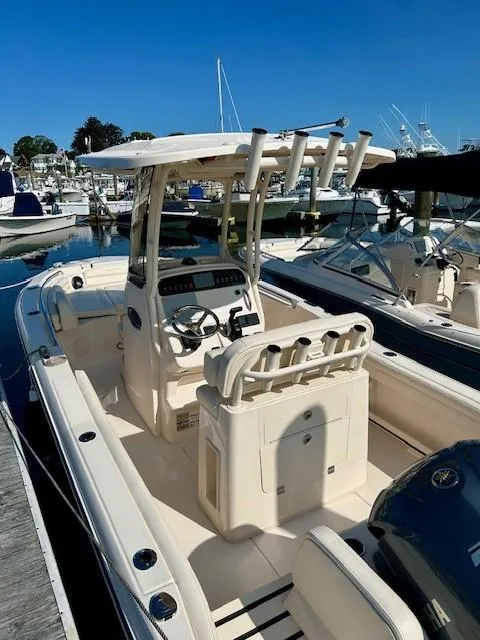 Slide: The Image of 2024 Grady-White Fisherman 216 boat docked at marina, featuring center console and rod holders. - 15