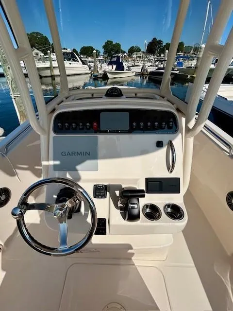 Slide: The Image of 2024 Grady-White Fisherman 216 boat console with Garmin navigation, docked at marina. - 5