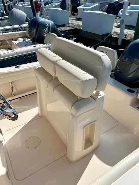 Slide: The Image of 2024 Grady-White Fisherman 216 boat interior with cushioned seating and steering wheel. - 6
