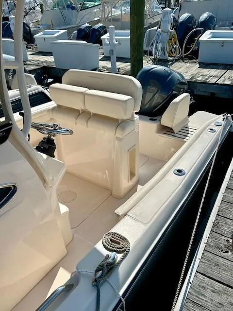 Slide: The Image of 2024 Grady-White Fisherman 216 boat docked, showcasing seating and deck features. - 8