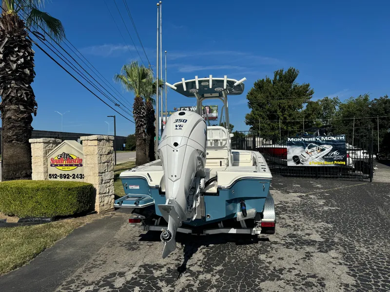 Slide: The Image of 2025 Pathfinder 2500 Hybrid boat with powerful outboard motor, parked outdoors. - 11