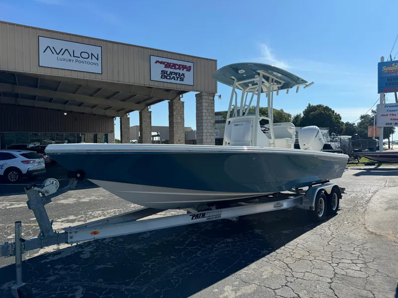 Slide: The Image of 2025 Pathfinder 2500 Hybrid boat on trailer at dealership. - 13