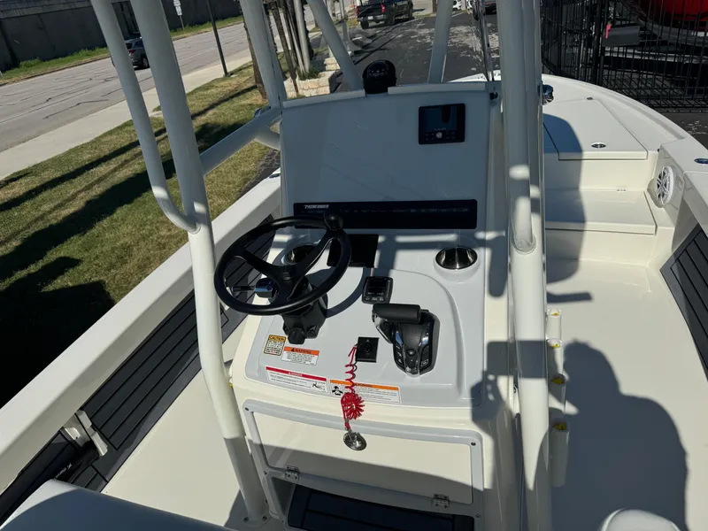 Slide: The Image of 2025 Pathfinder 2500 Hybrid boat console with steering wheel and controls. - 16