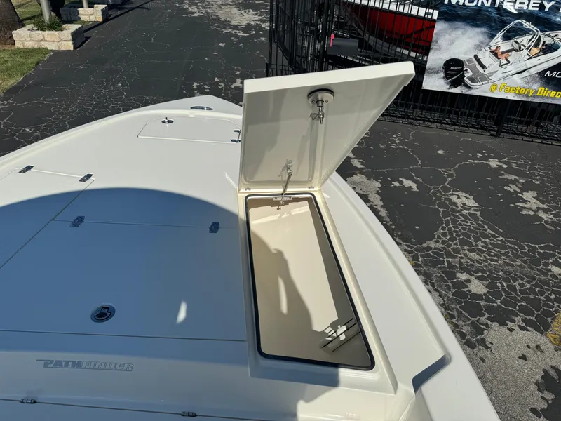 Slide: The Image of 2025 Pathfinder 2500 Hybrid boat with open storage compartment on deck. - 39