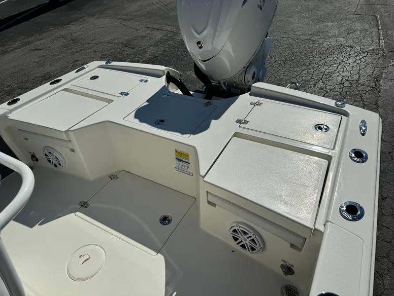 Slide: The Image of 2025 Pathfinder 2500 Hybrid boat deck with storage compartments and motor. - 46