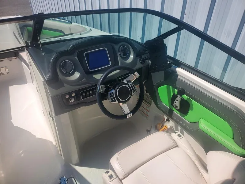 Slide: The Image of 2017 Chaparral Vortex 243 VRX boat interior with modern dashboard and green accents. - 3