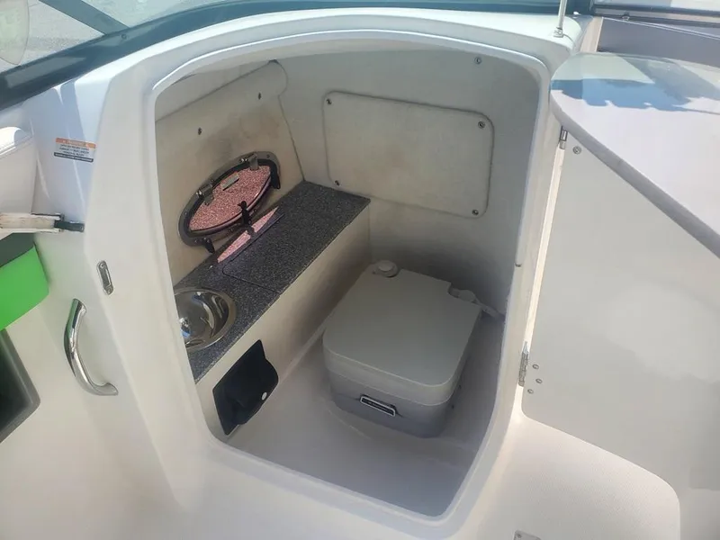 Slide: The Image of 2017 Chaparral Vortex 243 VRX boat interior with compact toilet and sink. - 7