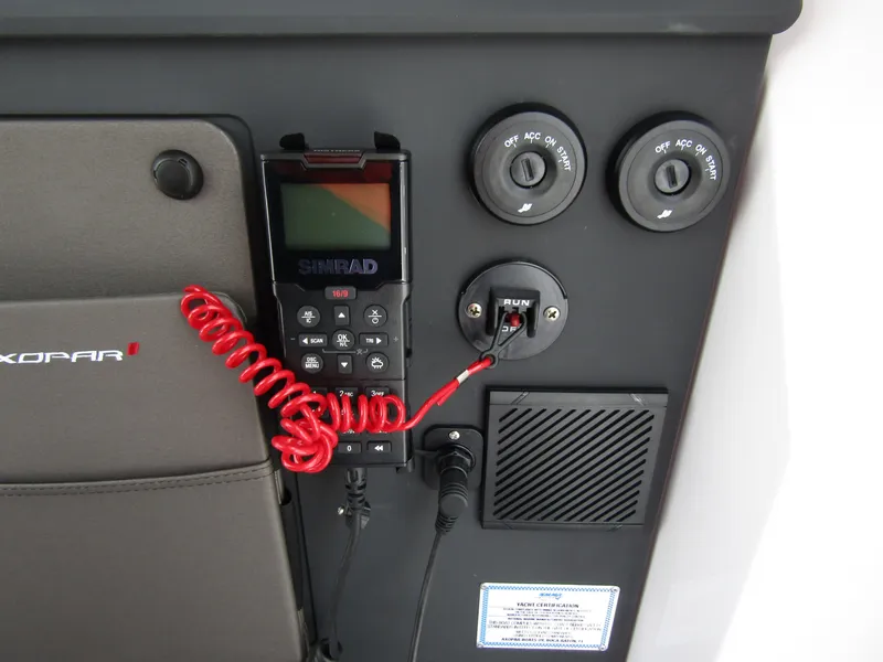 Slide: The Image of 2024 Axopar 37 Sun Top dashboard with controls and communication device. - 18