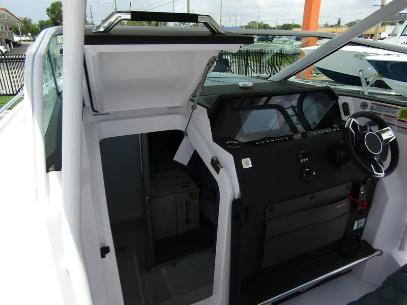 Slide: The Image of 2024 Axopar 37 Sun Top boat interior with modern helm and open cabin door. - 20