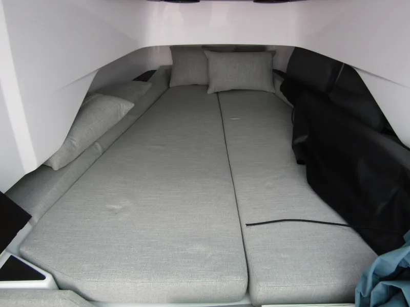 Slide: The Image of 2024 Axopar 37 Sun Top cabin interior with gray bedding and cushions. - 23