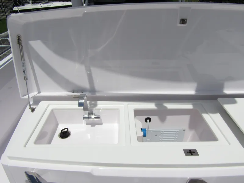 Slide: The Image of 2024 Axopar 37 Sun Top boat sink and storage area. - 26