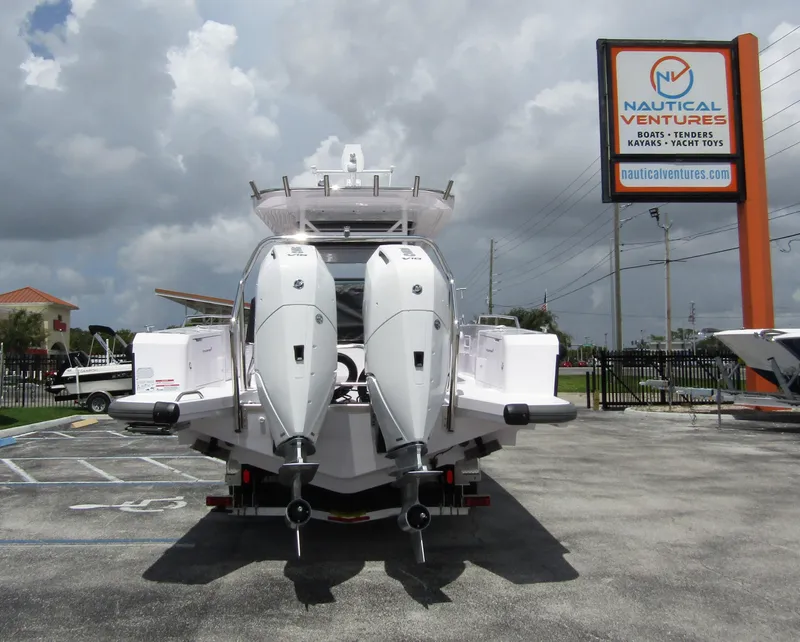 Slide: The Image of 2024 Axopar 37 Sun Top boat with dual engines at Nautical Ventures dealership. - 3