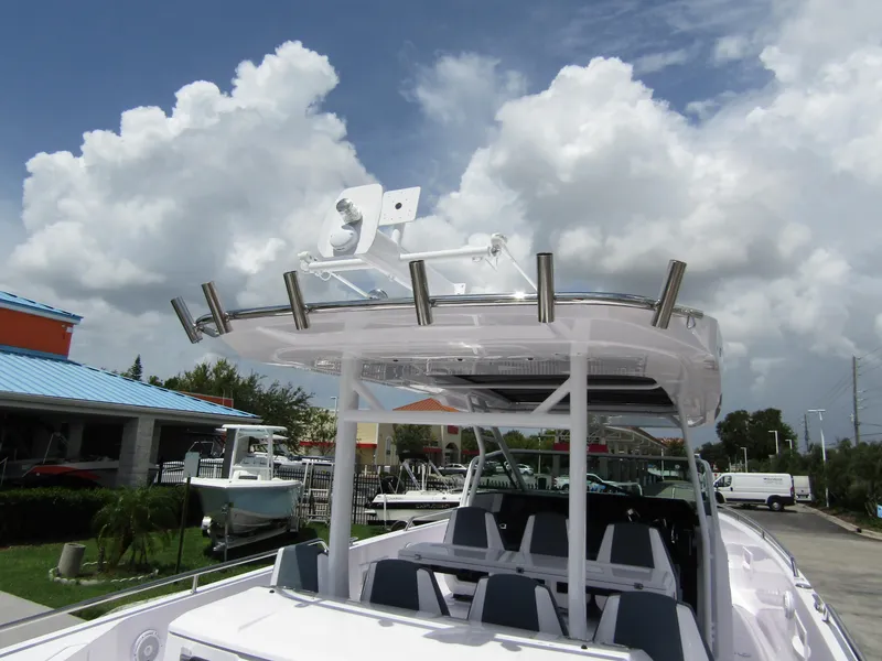 Slide: The Image of 2024 Axopar 37 Sun Top boat with sleek design under cloudy sky. - 31