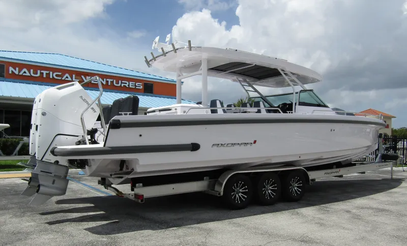 Slide: The Image of 2024 Axopar 37 Sun Top boat on trailer at Nautical Ventures dealership. - 4
