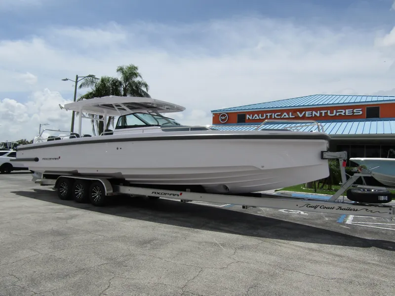 Slide: The Image of 2024 Axopar 37 Sun Top boat on trailer at Nautical Ventures dealership. - 6