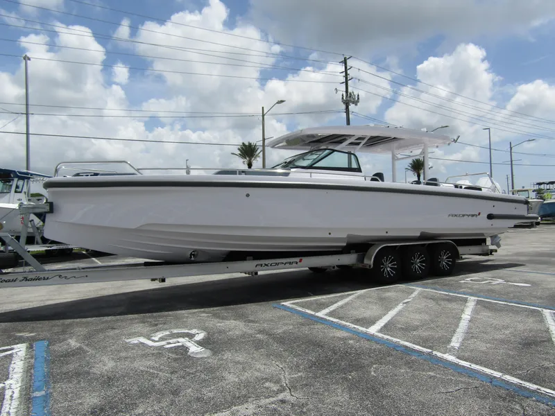 Slide: The Image of 2024 Axopar 37 Sun Top boat on trailer under cloudy sky. - 7