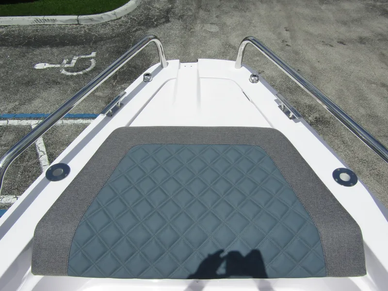 Slide: The Image of 2024 Axopar 37 Sun Top bow with quilted seating and stainless steel rails. - 8