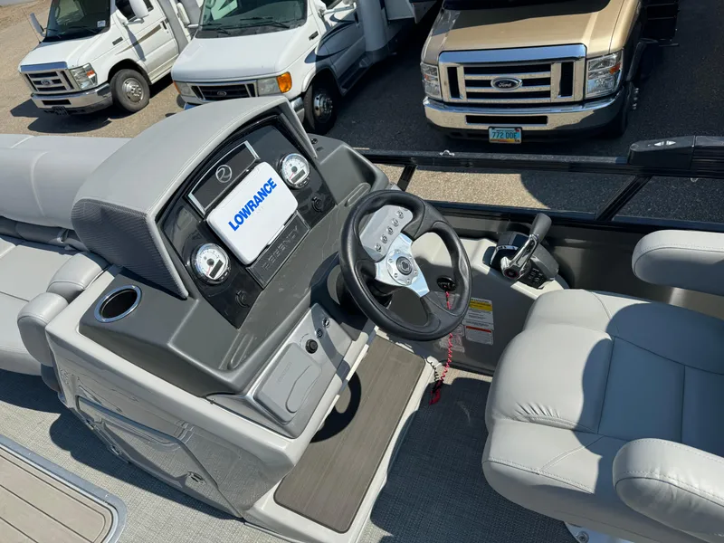 Slide: The Image of 2023 Regency 250 DL3 boat dashboard with steering wheel and Lowrance display. - 11
