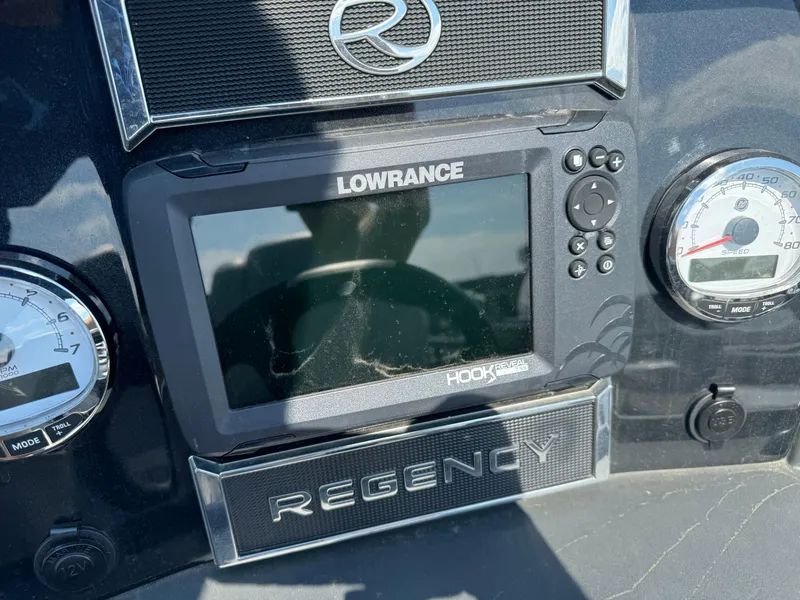 Slide: The Image of 2023 Regency 250 DL3 dashboard with Lowrance Hook display and gauges. - 14
