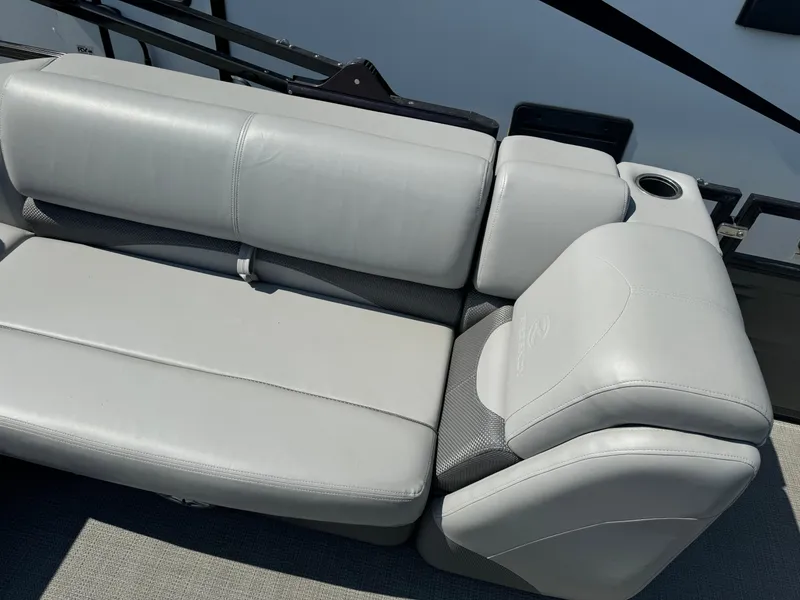 Slide: The Image of 2023 Regency 250 DL3 boat seat with cup holder, featuring sleek gray upholstery. - 16