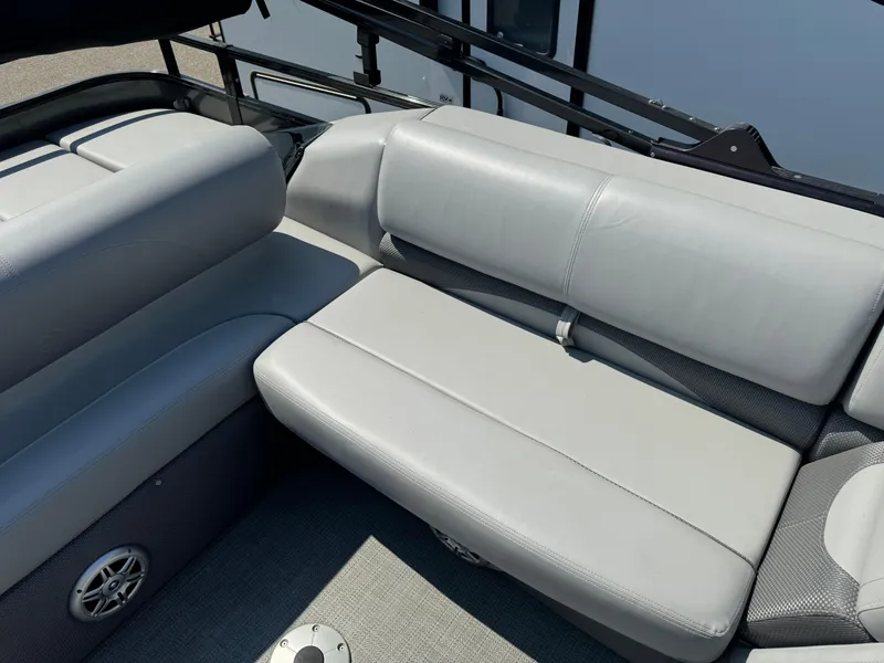 Slide: The Image of 2023 Regency 250 DL3 boat interior with gray seating and speaker. - 17