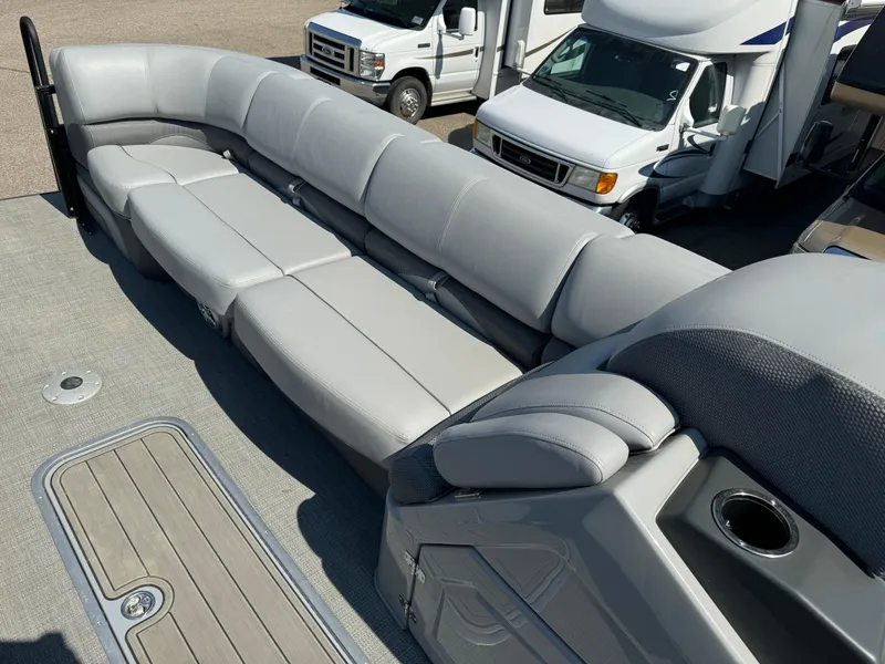 Slide: The Image of 2023 Regency 250 DL3 pontoon boat with spacious gray seating and cup holder. - 22