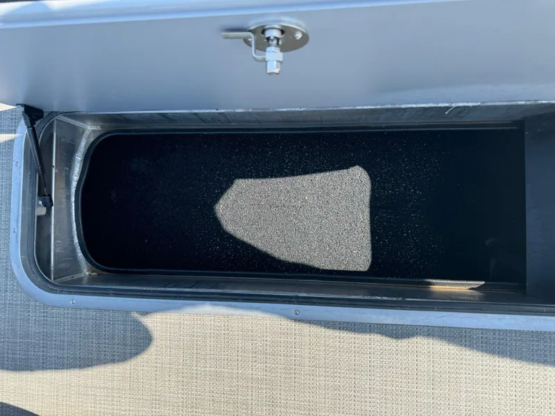 Slide: The Image of Storage compartment of 2023 Regency 250 DL3 boat, open with visible interior. - 24