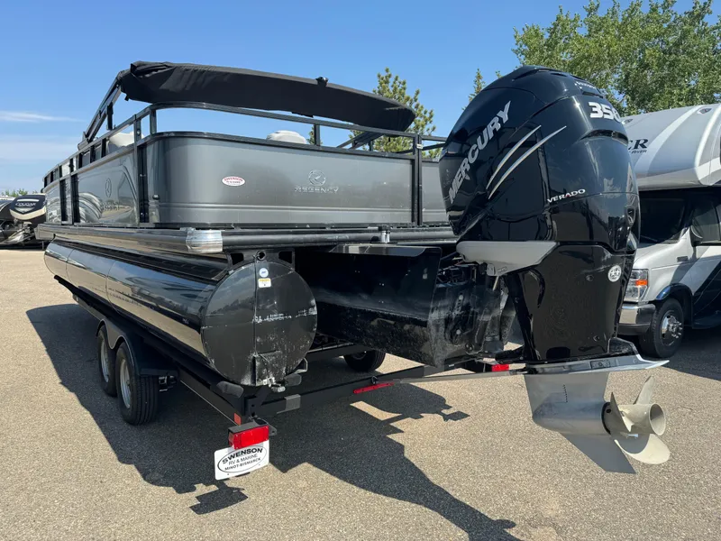 Slide: The Image of 2023 Regency 250 DL3 pontoon boat with Mercury engine, parked on a trailer. - 5