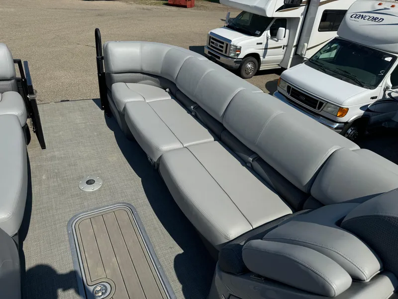 Slide: The Image of 2023 Regency 250 DL3 pontoon boat with spacious gray seating and deck. - 8