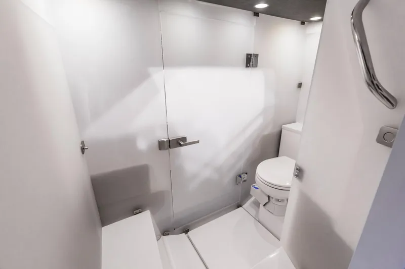 Slide: The Image of 2024 Axopar 37 Sun Top bathroom with modern white interior design. - 6